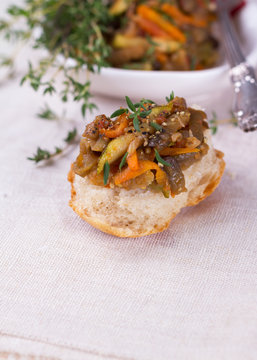 Vegetable ragout of eggplant, zucchini and carrots on slice of homemade bread 