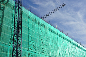 Building under construction, scaffolding, cranes