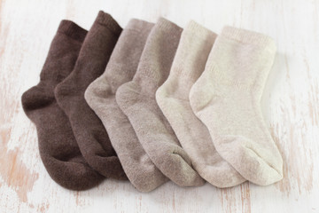 baby socks on white wooden background