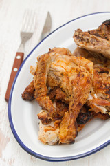 grilled chicken on white dish on white wooden background