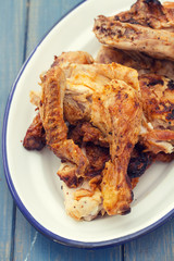 grilled chicken on white dish on blue wooden background