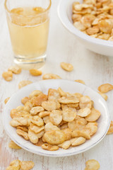 fried beans in white bowl on white wooden background