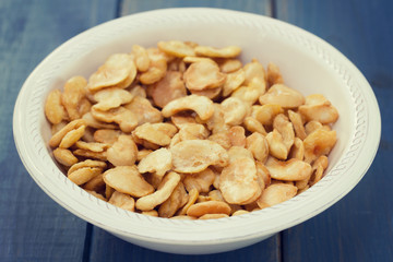 fried beans in white bowl on blue wooden background
