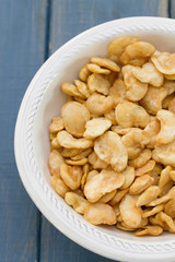fried beans in white bowl on blue background