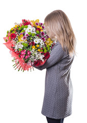 girl with brown hair with a beautiful bouquet in hand back to th