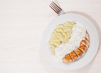 Sliced fried chicken fillet in a creamy and mustard sauce with mashed potatoes