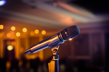 Wireless microphone stand on the stage venue with blur bokeh bac