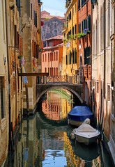Fototapeta na wymiar Narrow channel street in Venice, Italy