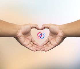 Human hand holding Mars Venus or Male Female symbol. Safe Sex co
