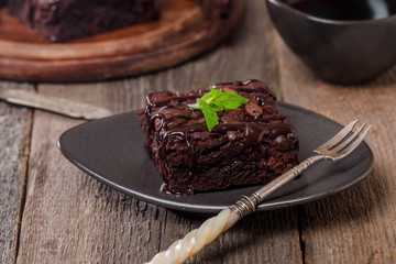 Cake chocolate brownies with dark chocolate  dressing and mint
