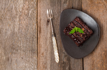 Cake chocolate brownies with dark chocolate  dressing and mint