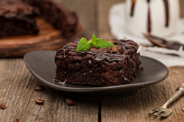 Cake chocolate brownies with dark chocolate  dressing and mint