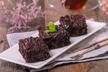 Cake chocolate brownies with dark chocolate  dressing and mint