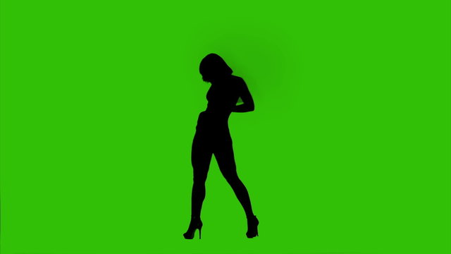 Silhouette of dancing female on green background