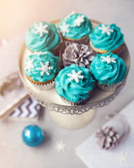 Obraz na płótnie Canvas Blue cupcakes with snowflakes at Christmas