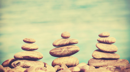 Fototapeta na wymiar Retro style stones on a beach, spa concept background