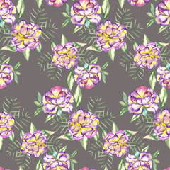 A seamless floral pattern with the watercolor violet and yellow exotic flowers and green leaves painted on a grey background