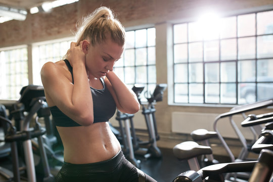 Woman resting after cycling workout in gym