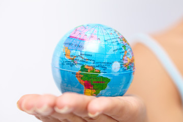 woman's hand with globe