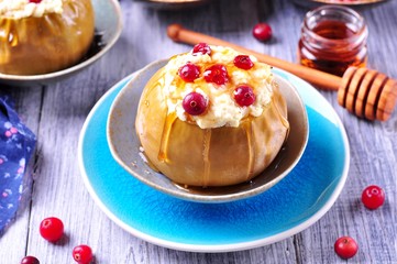 Apples baked with cheese and cranberries poured honey. Healthy breakfast.