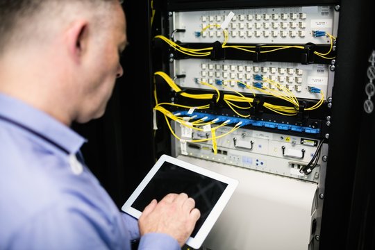 Technician looking at open server locker