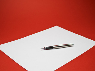 ball point pen on white paper with red background