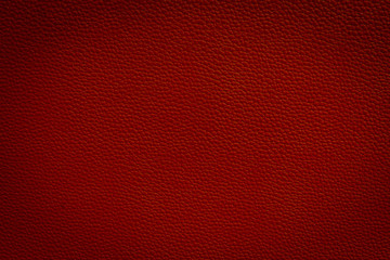 Red leather texture closeup detailed background.