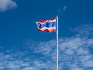 Fototapeta premium waving flag of Thailand with blue sky background