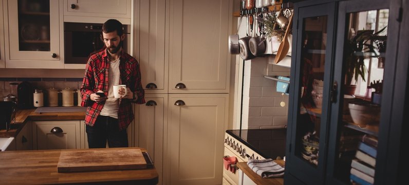 Handsome hipster relaxing in kitchen