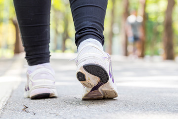 Closeup of running shoes of woman jogging in park
