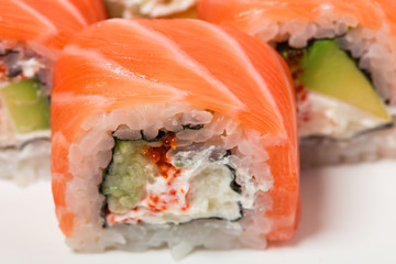 Uramaki salmon roll with scallops.