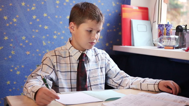 Teenage boy sitting and preparing his homework