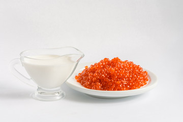 red caviar with jug of cream
