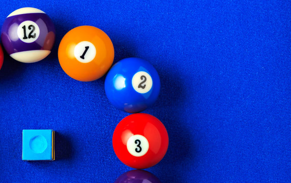 Billiard balls in a blue pool table.