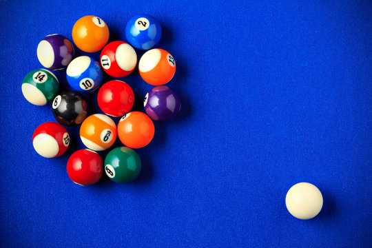 Billiard Balls In A Blue Pool Table.