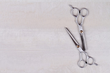 Scissors on white wooden background. Hairdresser salon concept. Haircut accessories