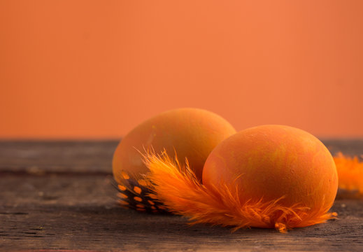 beautiful orange easter eggs on wooden background