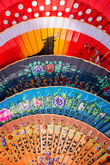Background of colorful Spanish fans in Seville, Andalusia, Spain