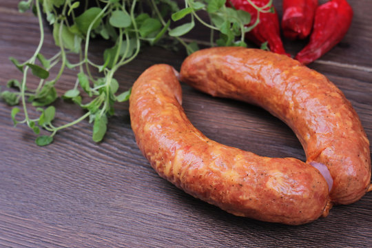 Raw homemade Kranjska sausages on wooden background