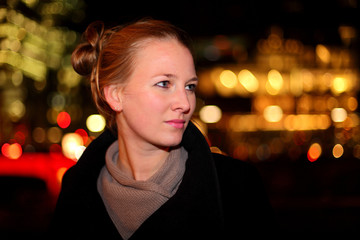 Blonde woman in the city at night