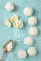 Coconut candies on aquamarine wood