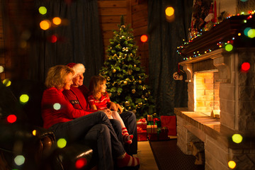 Happy family by a fireplace on Christmastime