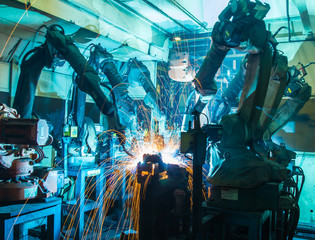 Team Welding robots movement in a car factory