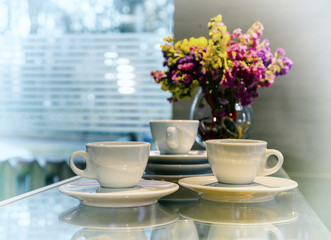 Three cups of coffee against the window, vintage