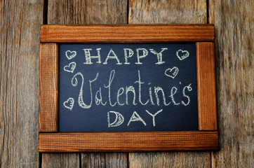 happy Valentines day written on the chalk Board