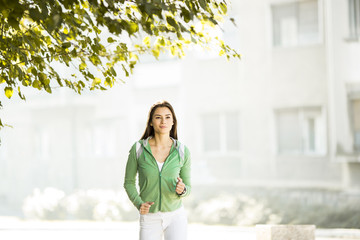 Fototapeta premium Young woman running in the park