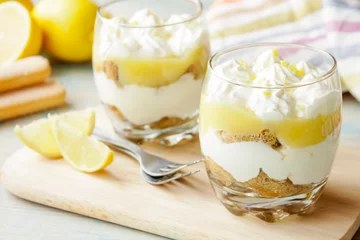 Rolgordijnen Lemon tiramisu in a glass © yuliiaholovchenko