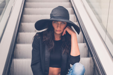 Beautiful girl posing on an escalator