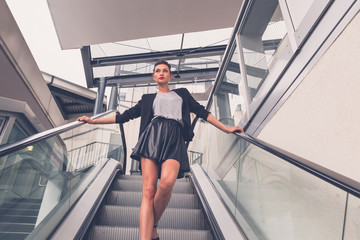 Beautiful girl posing on an escalator