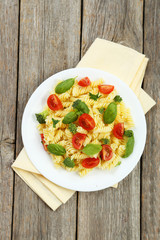 Delicious pasta on plate on grey wooden background